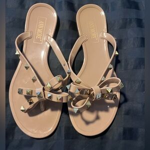 Tan flip flops with Gold details